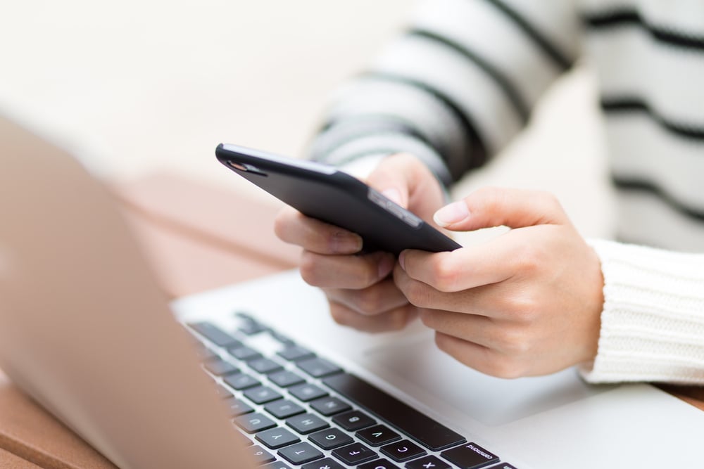 Woman sending text message on cellphone